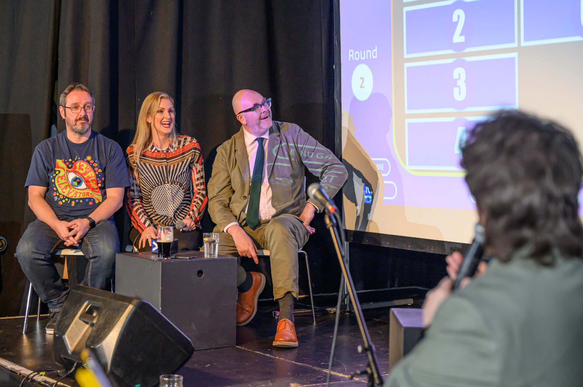 Panellists laughing during a live stage session