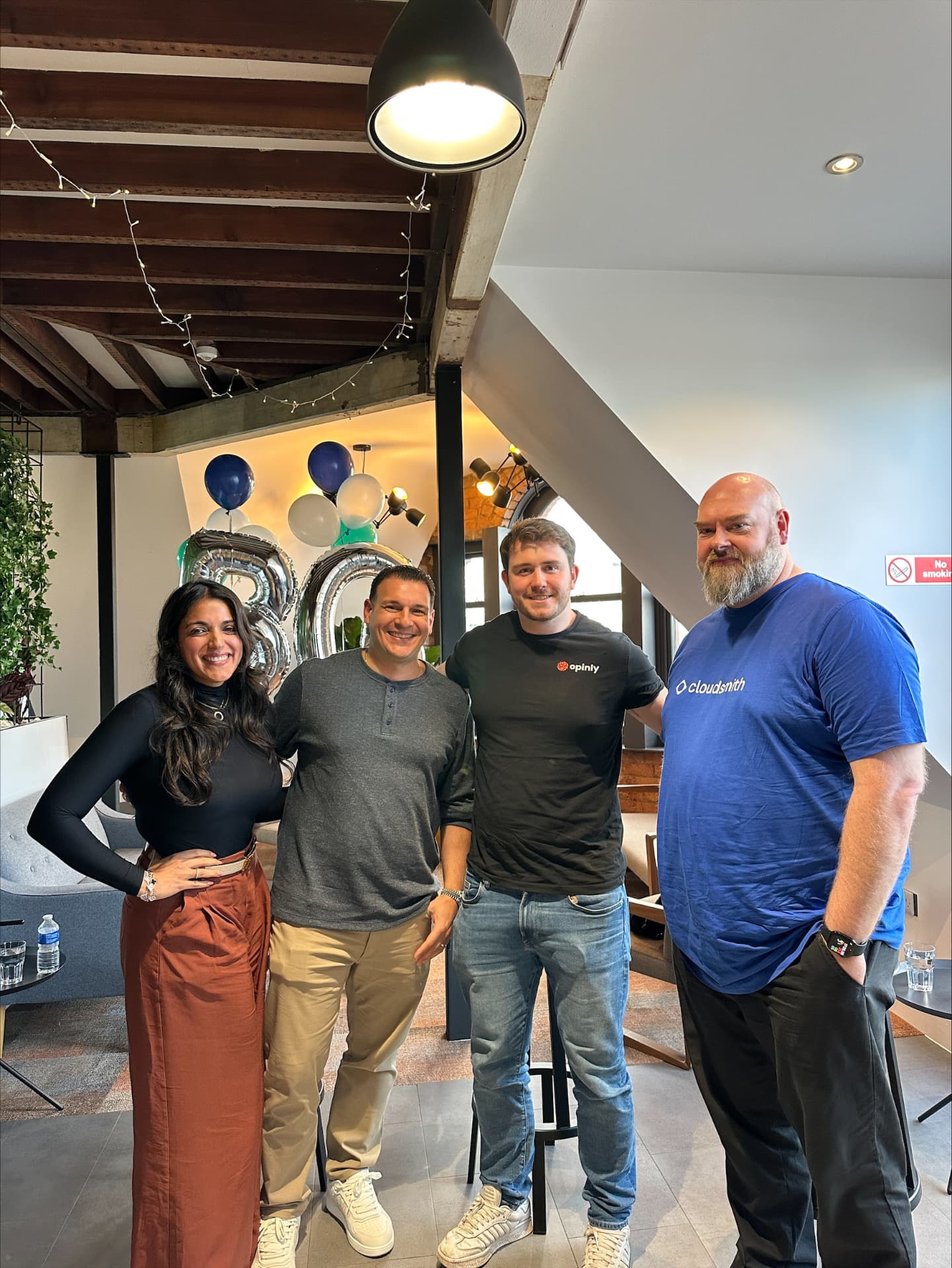 Four people smiling together at a Biller Genie panel event